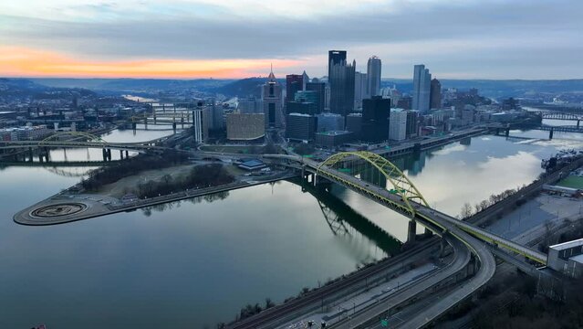 High aerial shot of Fort Pitt Bridge and Pittsburgh skyline during cold winter sunrise. Drone view as seen from Duquesne Incline on Mount Washington.