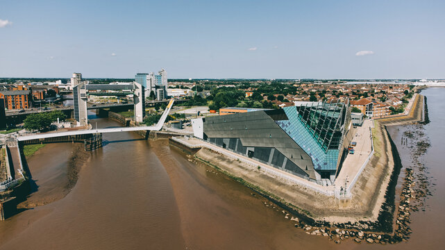 Hull City drone image including the Deep aquarium, and the tidal barrier at the crossing point of the Humber Estuary and the River Hull. Industrial and pier near the old town.