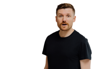 Good looking ginger man being in shock, looking at camera with amazement