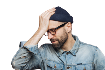 Horizontal portrait of stressful stylish unshaven male regrets something, keeps hand on head, looks down in despair, isolated over pink background. European man recieves failure, poses indoor