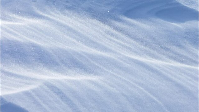 Beautiful white abstract natural background of snowy ice surface of Baikal Lake on frosty windy day. Frozen waves texture. Top view of layered structure of snow crust. Flat lay, copy space, mock up