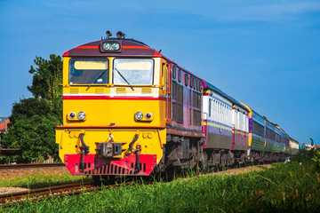Obraz premium Passenger train by diesel locomotive on the railway.