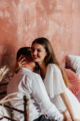 a man kisses a pregnant woman on the neck