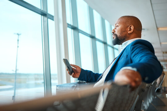 Travel, thinking and phone with black man in airport for social media, business trip and and networking. Communication, vacation and email with passenger on layover for first class, app and contact