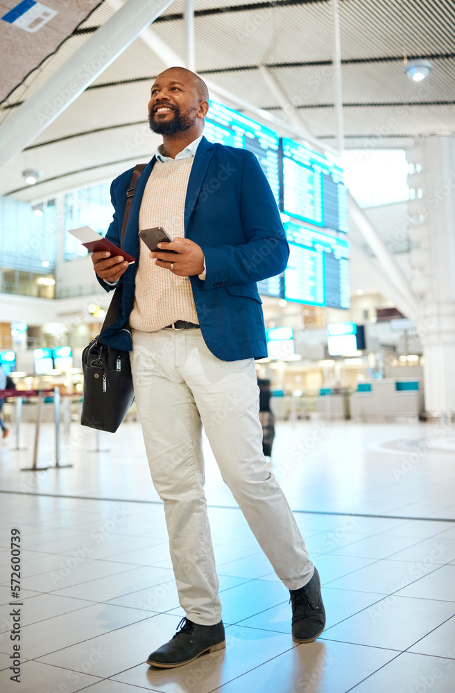 Wall mural black man walking in airport with phone and ticket, checking flight schedule in terminal and holding