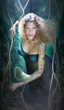 Beautiful blonde mermaid underwater posing, glamour pretty woman with sensual face, green eyes, attractive fantasy creature, charming and seductive young lady in fishing net, photo based AI Generative