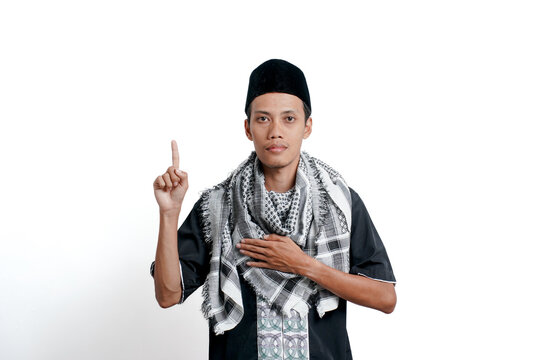 Religious muslim asian man wearing turban, muslim dress and cap. Have faith in God by lifting one finger. isolated on white background.