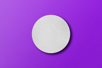 paper cut into circle shape with light and shadow Placed on a purple paper background.
