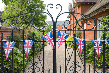 Union Jack bunting on gates outside a UK country house