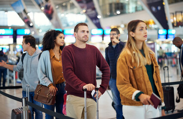 Obraz na płótnie Canvas Travel, queue and wait with man in airport for vacation, international trip and tourism. Holiday, luggage and customs with passenger in line for airline ticket, departure and flight transportation
