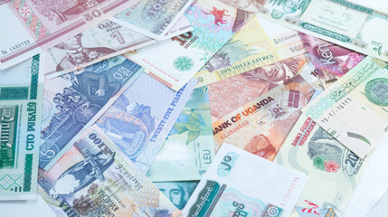 Fototapeta na wymiar Various currencies. Banknotes, money from different countries. Diversification of the investment portfolio. Investing in financial instruments, saving. Inflation, exchange rates.
