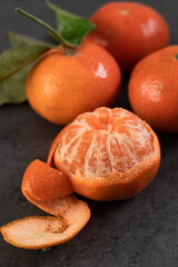 fresh tangerines with leaves on a dark background.Close up