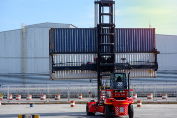 forklift truck Container boxes in a logistics yard with a stack of containers in the background.