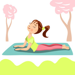 The girl is doing yoga in the park. Spring activities. The girl does the cobra pose on the rug. Hello spring concept.