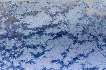 Frosty drawing on the window close-up in winter