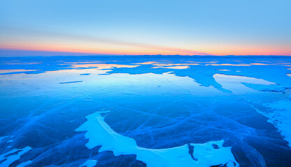 Fototapeta na wymiar Frozen lake Baikal in winter season at amazing sunset, Olkhon island in Siberia, Russia