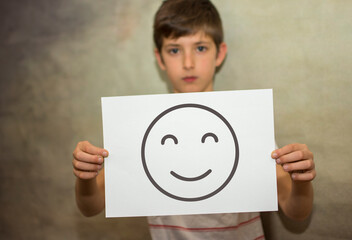 A child holding with his arms a happy message