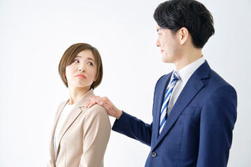 ビジネスウーマンの肩を触るビジネスマン　白背景