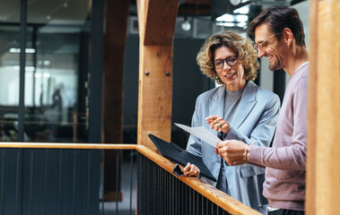 Business people analysing a financial report together. Two business people discussing in an office