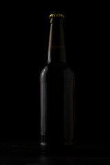 A bottle of beer on a black background