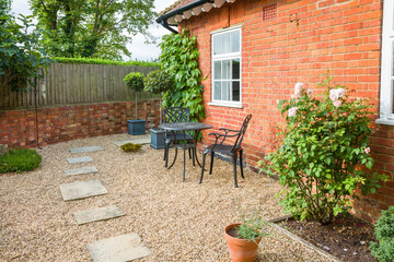UK garden patio design with hard landscaping and furniture