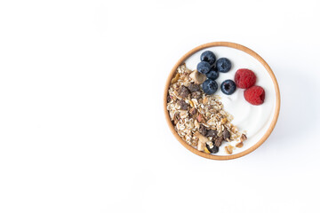 Yogurt with berries and muesli for breakfast in bowl isolated on white background. Top view