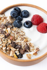 Yogurt with berries and muesli for breakfast in bowl isolated on white background. Close up
