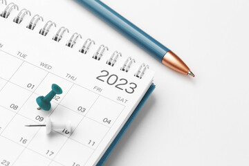 Scheduling and planning concept, calendar with blue pin and pen