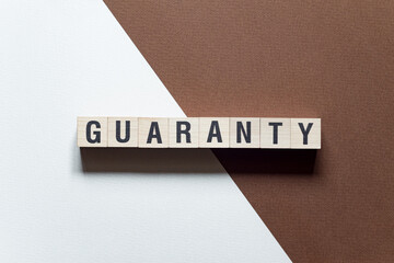 Guaranty - word concept on cubes
