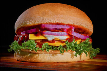 burger with bacon and cheese on a black background