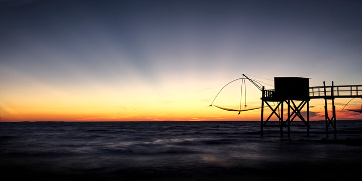 Last sun rays over fishing cabon