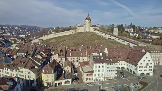 Aerial view of the old town of City of Schaffhausen with famous Munot fortification on top of a hill with historic houses and vineyard. Movie shot February 16th, 2023, Schaffhausen, Switzerland.