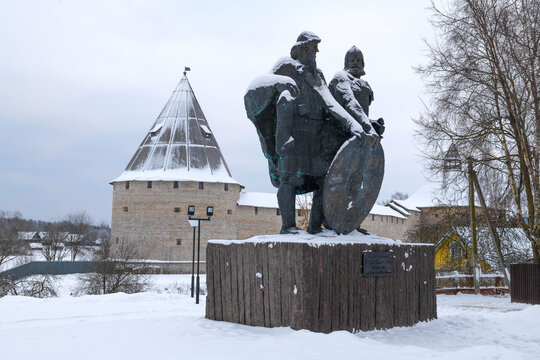 STARAYA LADOGA, RUSSIA - DECEMBER 11, 2022: Monument to princes Rurik and Prophetic Oleg - the founders of the Russian state against the background of the ancient Staraya Ladoga fortres