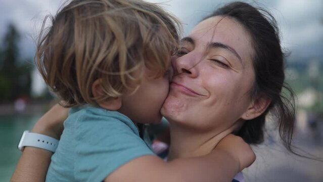 Cute mother and child bonding moment. Loving caring parent and child embrace. Lifestyle parenting hug and love outdoors