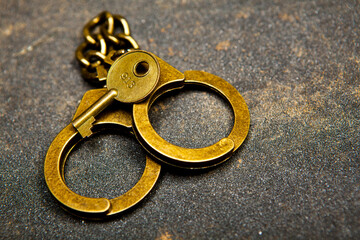 image of handcuffs key asphalt background