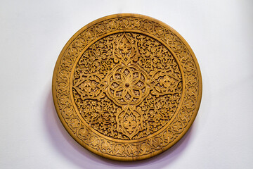 Fragment of an ancient carved wooden round plate. Ornate.