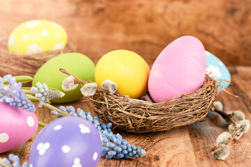 Easter eggs with spring flowers on wooden table. Easter concept