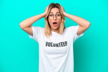 Young volunteer Uruguayan woman isolated on blue background with surprise expression