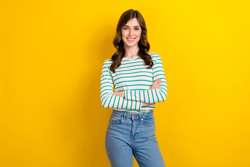 Photo portrait of lovely young lady folded arms confident entrepreneur wear trendy striped garment isolated on yellow color background