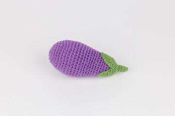 blue eggplant on a white background children's knitted toy