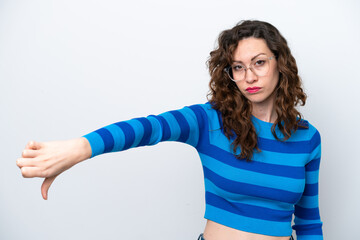 Young caucasian woman isolated on white background showing thumb down with negative expression