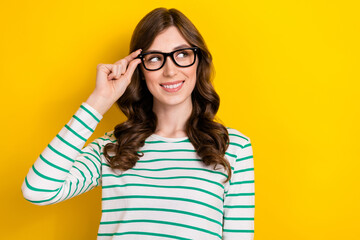 Photo of smart intelligent person young attractive girl touch eyewear optician glasses vision looking empty space isolated on yellow color background