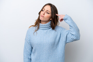 Young caucasian woman isolated on white background making the gesture of madness putting finger on...