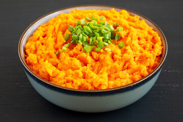 Homemade Creamy Mashed Sweet Potatoes with MIlk and Butter in a Bowl, side view.