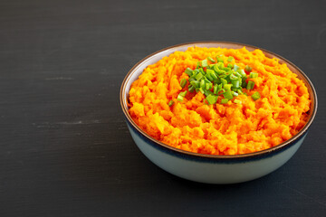 Homemade Creamy Mashed Sweet Potatoes with MIlk and Butter in a Bowl, side view. Copy space.