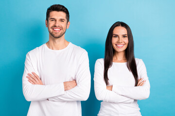 Photo portrait of cute young man woman crossed folded arms toothy smile wear trendy white clothes isolated on blue color background