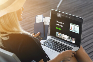 Woman fills out application to Consular Section of Embassy to obtain visa online.