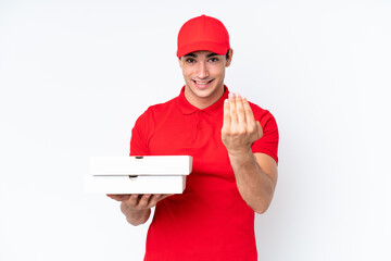 Pizza delivery caucasian man with work uniform picking up pizza boxes isolated on white background...