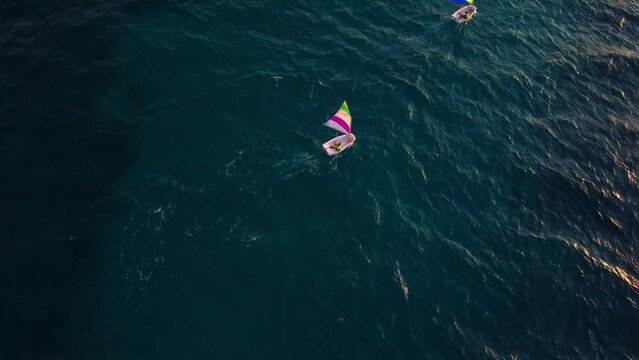 training of children on sailing boats optimist in Mediterranean sea