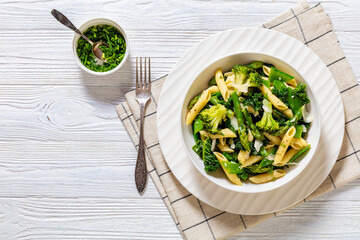 Pasta primavera with green veggies, cheese in bowl